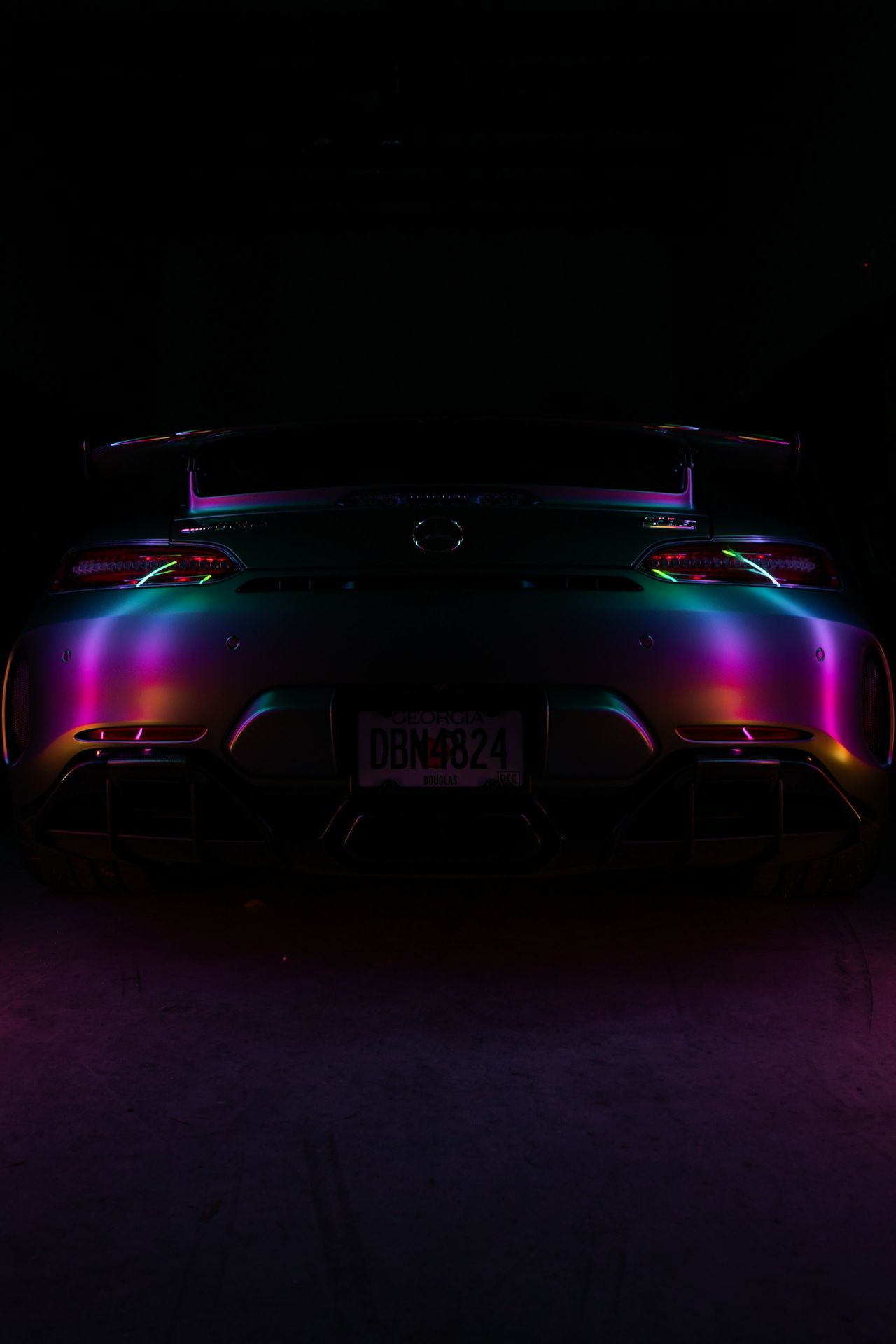 A car with neon lights in the dark